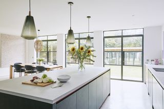 contemporary handleless kitchen with steel doors and polished concrete floor