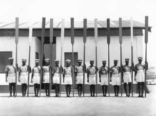 Archive photo of people lined up with paddles