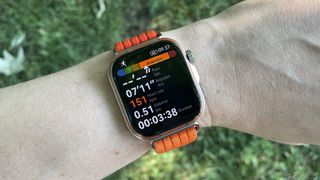 Huawei Watch Fit 5 Pro worn on a run, in front of a grassy background
