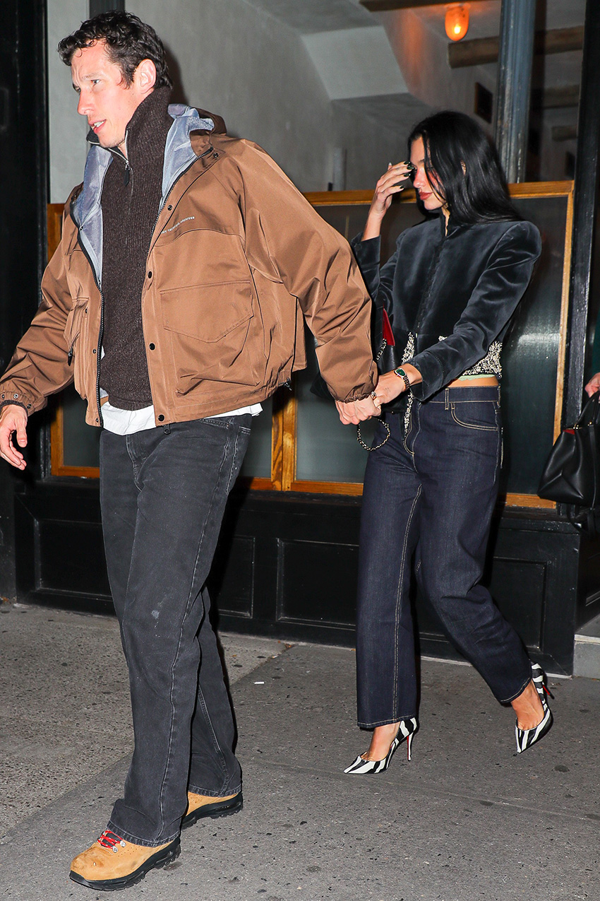Dua Lipa wearing a cropped black velvet jacket with dark denim jeans and zebra-print pumps in NYC