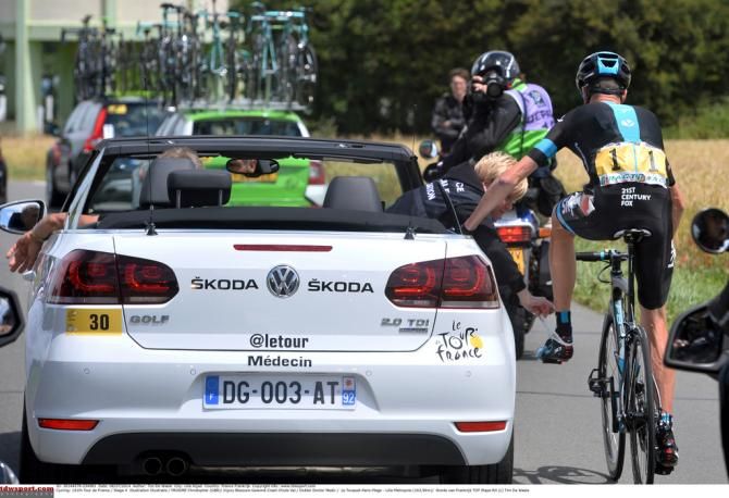 The race doctor attends to the left side of Froome