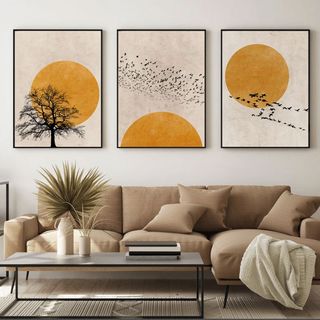 Japandi style sunset artwork set of 3 prints above a beige sofa in living room