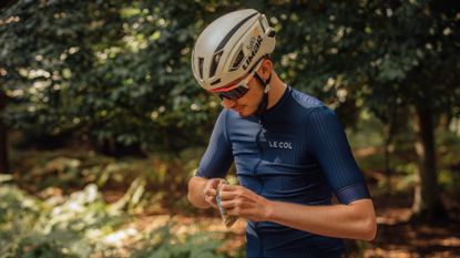 Male cyclist opening an energy bar on a bike ride