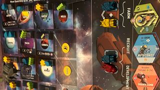 Planetary and action tiles, along with a mothership token, on the Apiary board