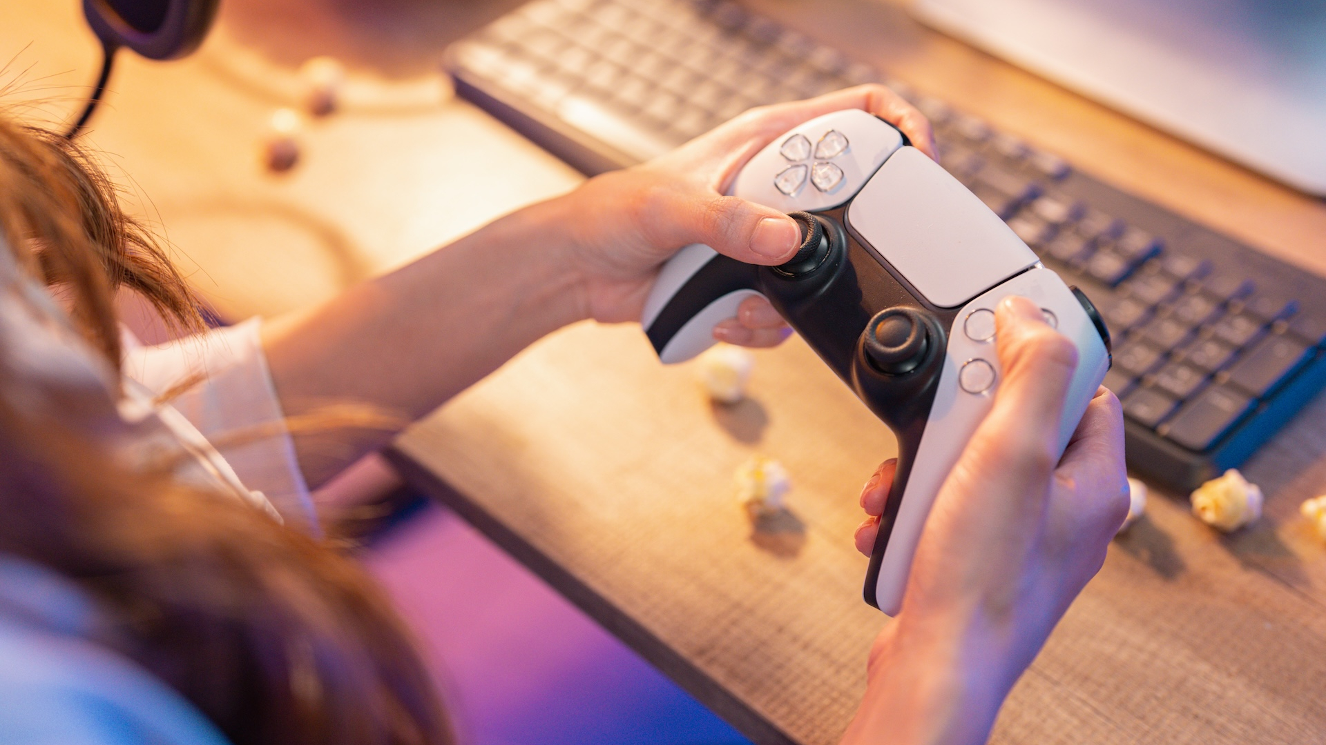 A person using a PS5 controller at home 