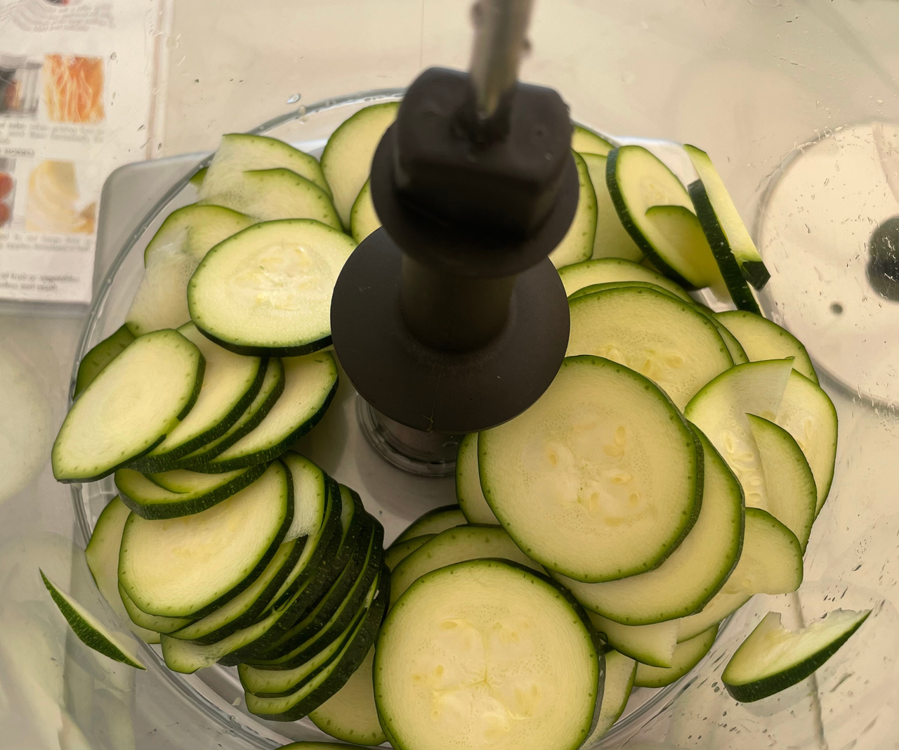 sliced cucumber in the base of a food processor unit.