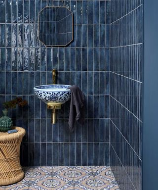 blue tiled bathroom with blue and white patterned washbasin