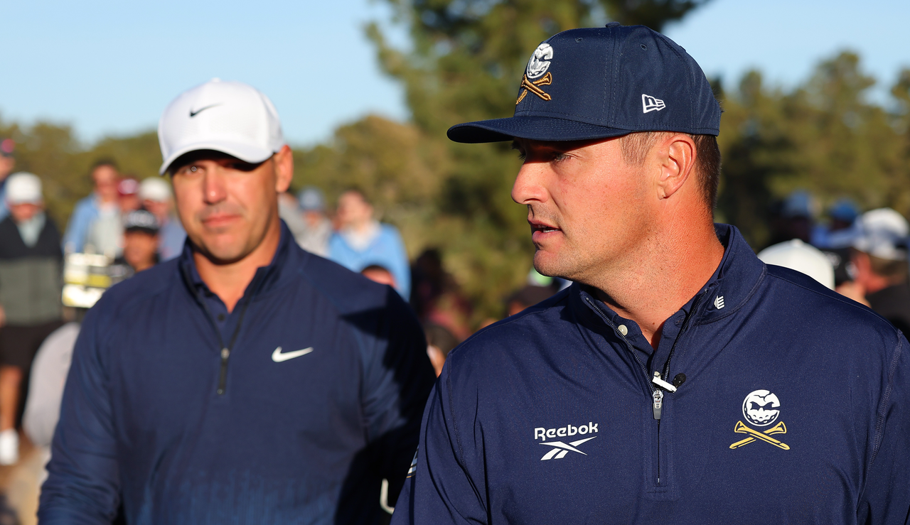 Brooks Koepka and Bryson DeChambeau walk off the tee box