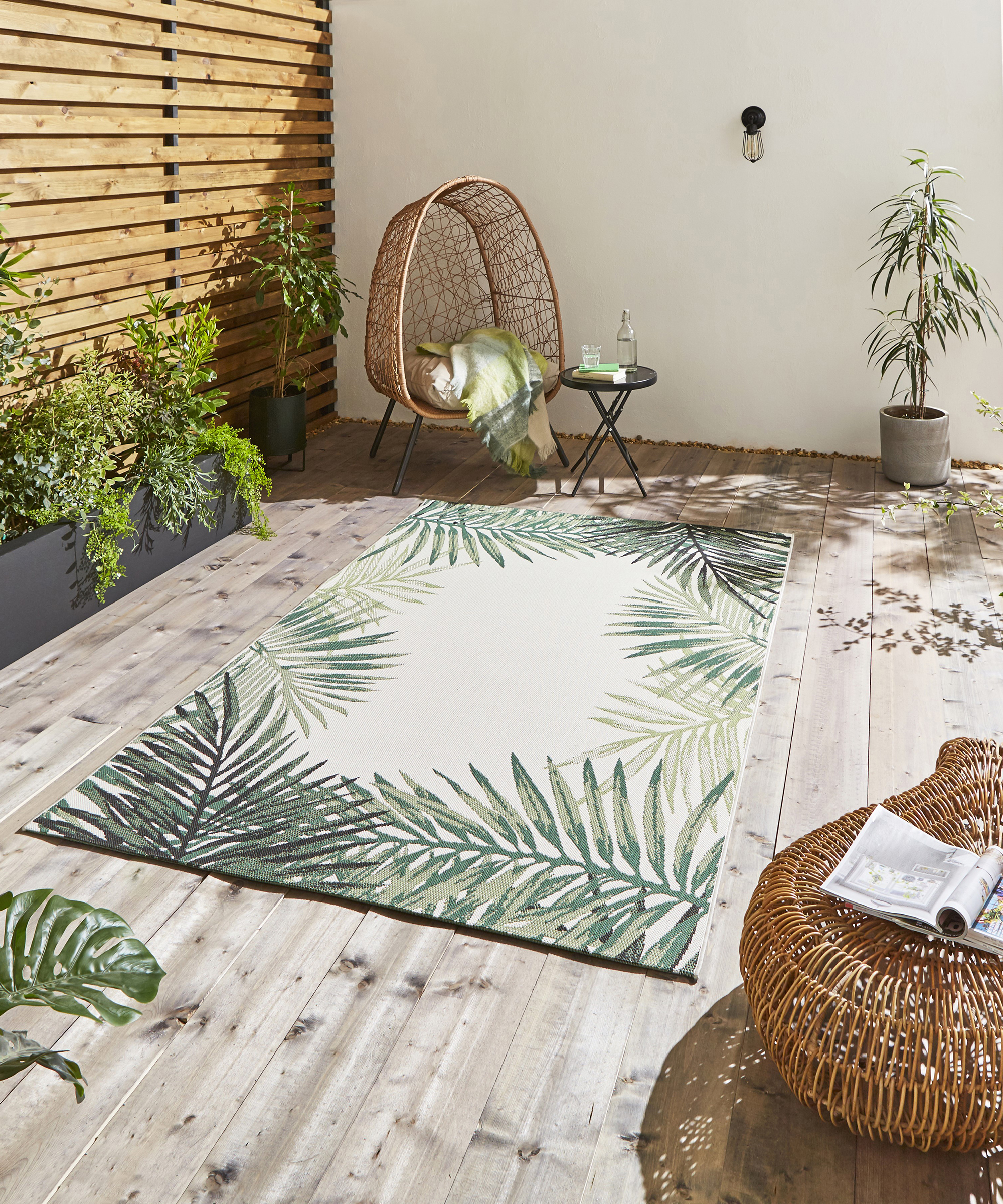 Outdoor rug, egg chair and planted tree on deck idea by The Rug Retailer