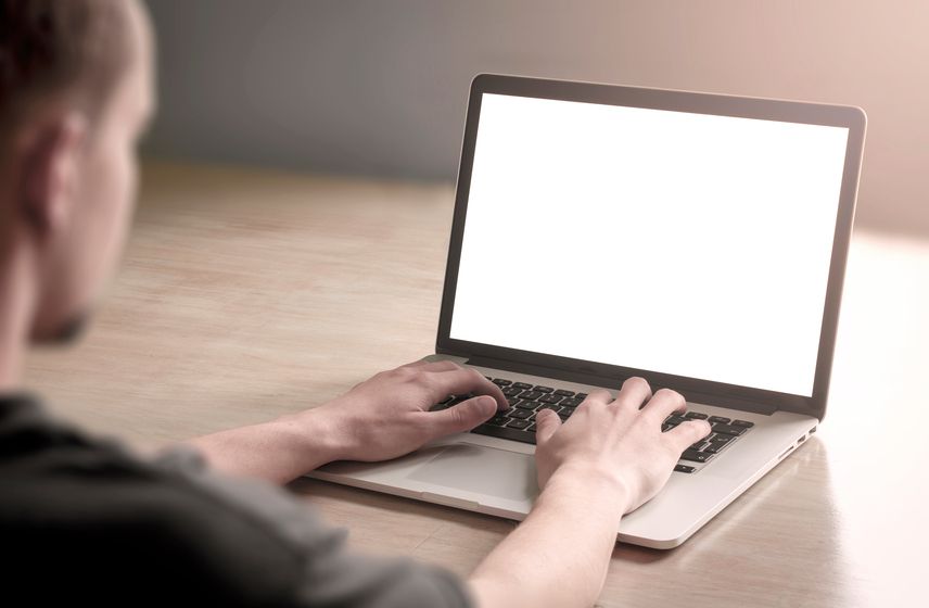 A man uses a laptop computer.