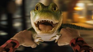 Someone is holding a swinging Lyle the Crocodile in Lyle, Lyle, Crocodile on Netflix