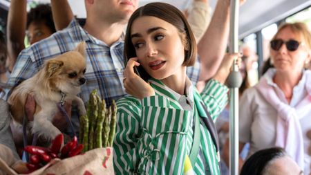 Emily looks at a dog on a packed bus