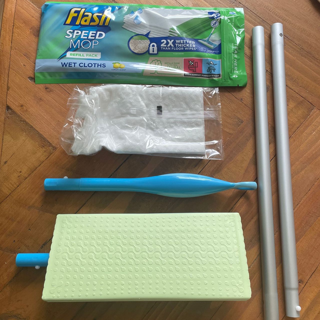 Flash Speed Mop Starter Kit components laid out on a wooden table