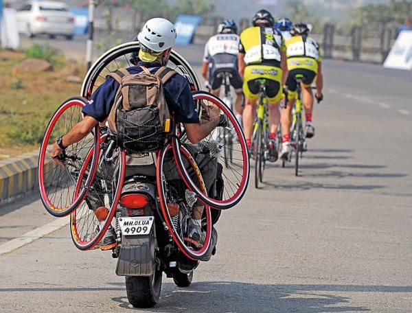 A neutral support mechanic has his hands full at India's Mumbai Cyclothon.