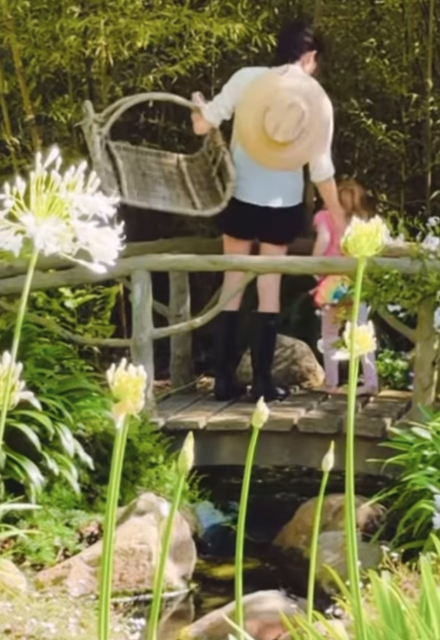 Meghan Markle and Princess Lilibet pick fruit in their garden, and Lilibet is carrying a Jellycat bag, a brand beloved by her cousin Princess Charlotte