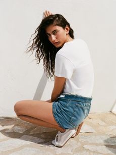 Female Model in Arket blue shorts and a white t-shirt