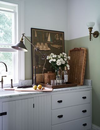 white kitchen detail with boat picture and angled light