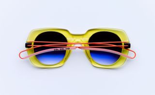 Yellow rim glasses with red wire arms