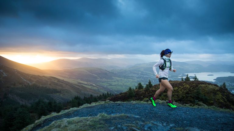 Best trail running shoes: person running at dawn wearing trail running shoes
