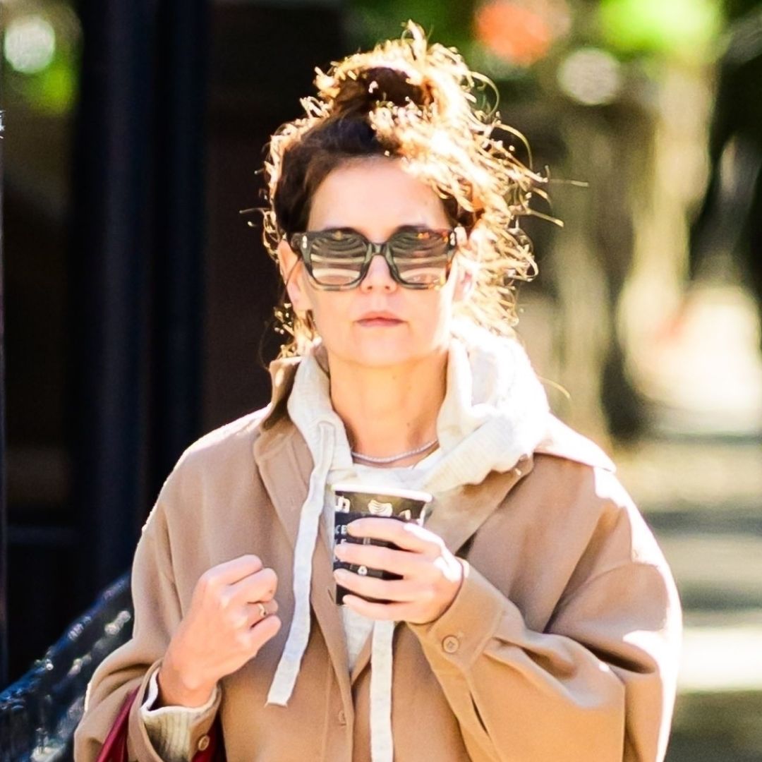 Katie Holmes carrying her Metier red bag and wearing wide-leg jeans and Autry sneakers