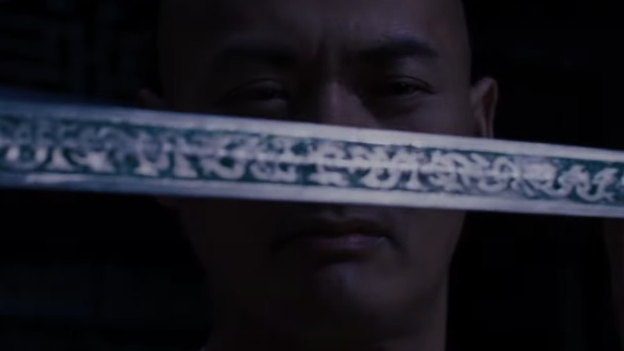 Chow Yun-fat holding a blade before his face in Crouching Tiger, Hidden Dragon