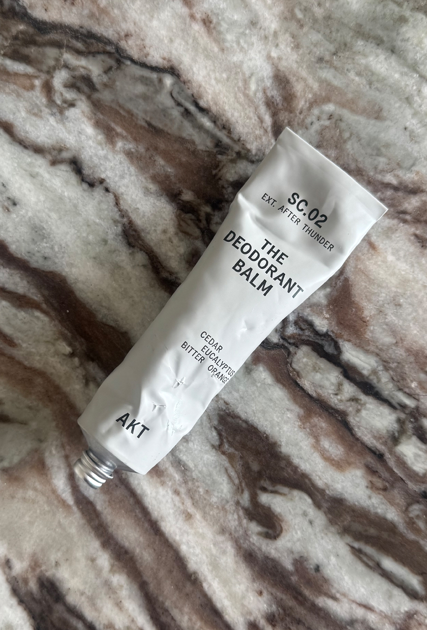 AKT The Deodorant Balm in the After Thunder scent on marble tablr