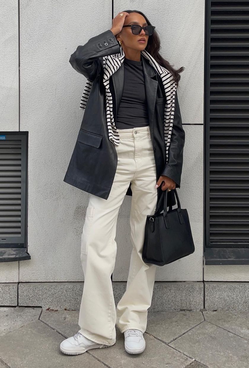 @ingridedvinsen wears white baggy jeans, a black leather blazer, black and white striped knit, white trainers and a black leather bag
