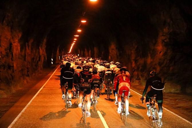 The Actic Race of Norway peloton negotiates a tunnel during stage 1