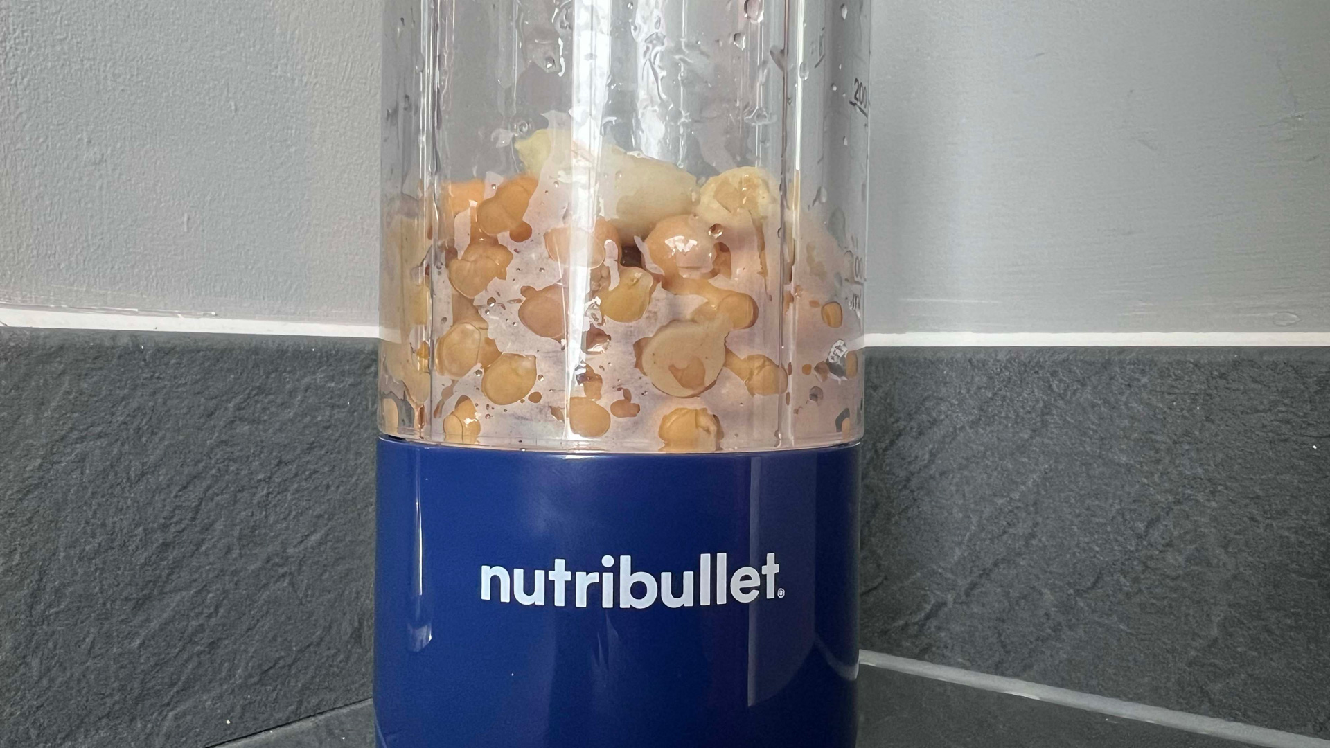 Chick peas and garlic in the Nutribullet Magic Bullet portable blender for making hummus