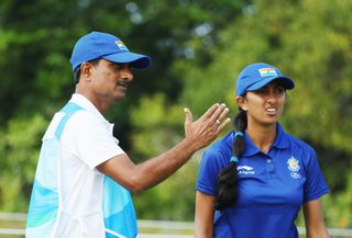 Aditi Ashok talks to her father Pandit Gudlamani during the Rio 2016 Olympic women's golf tournament