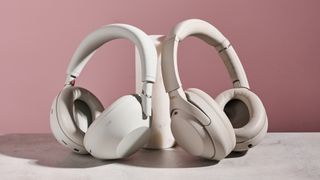 Sony WH-1000XM6 and Sony WH-1000XM4, both leaning against a cylindrical post