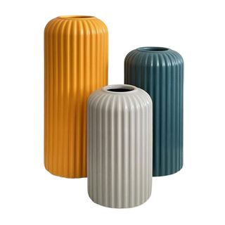 Three vases in varying heights one yellow, one blue, and one gray
