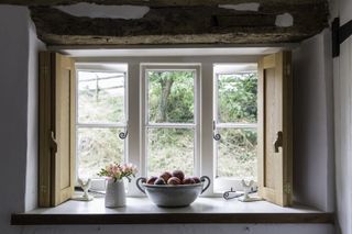 Deep window sill and beams in the kitchen of a grade II listed thatched cottage