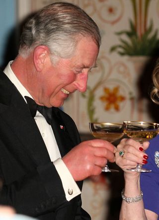 King Charles toasting with a coupette glass