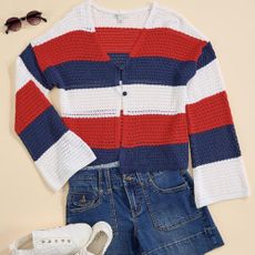A red, white and blue sweater with sunglasses, jean shorts and white trainers