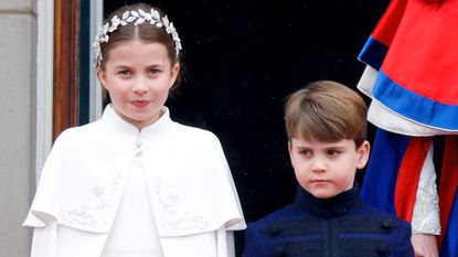 Princess Charlotte of Wales and Prince Louis of Wales watch an RAF flypast from the balcony of Buckingham Palace following the Coronation of King Charles III &amp; Queen Camilla 