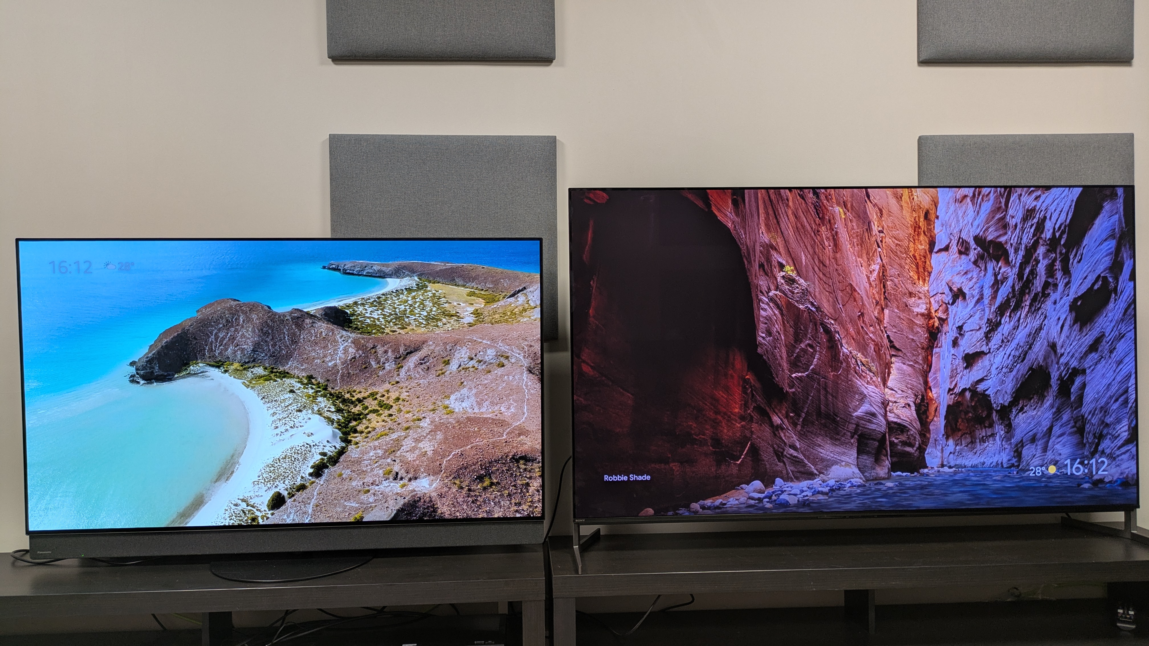 Panasonic Z95B (left) and Sony Bravia 8 II (right) displaying a beach (Panasonic) and a valley (Sony) as screensavers on screen 