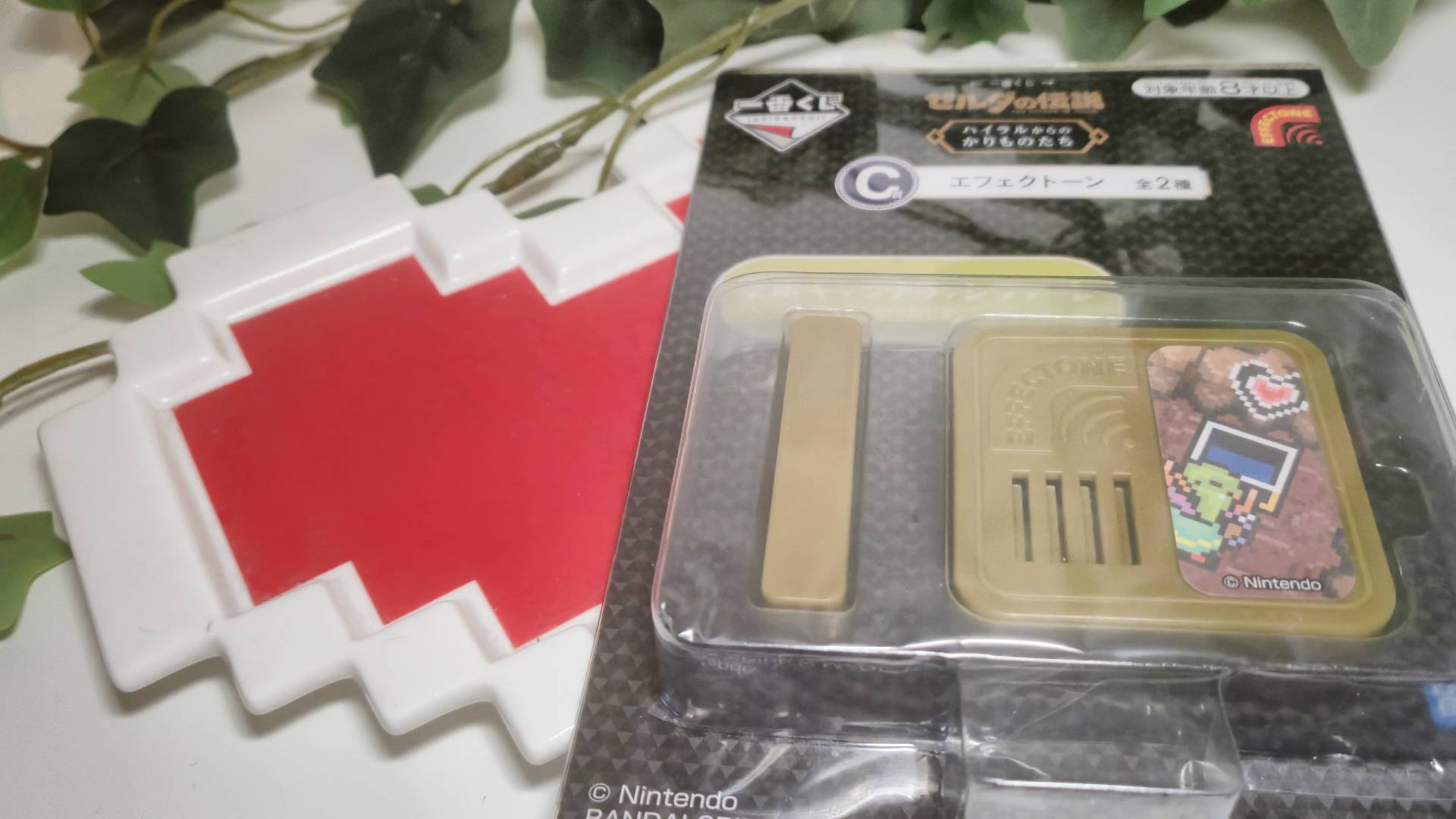 Photo of one of the Zelda Effectones sitting on a Zelda heart plate.