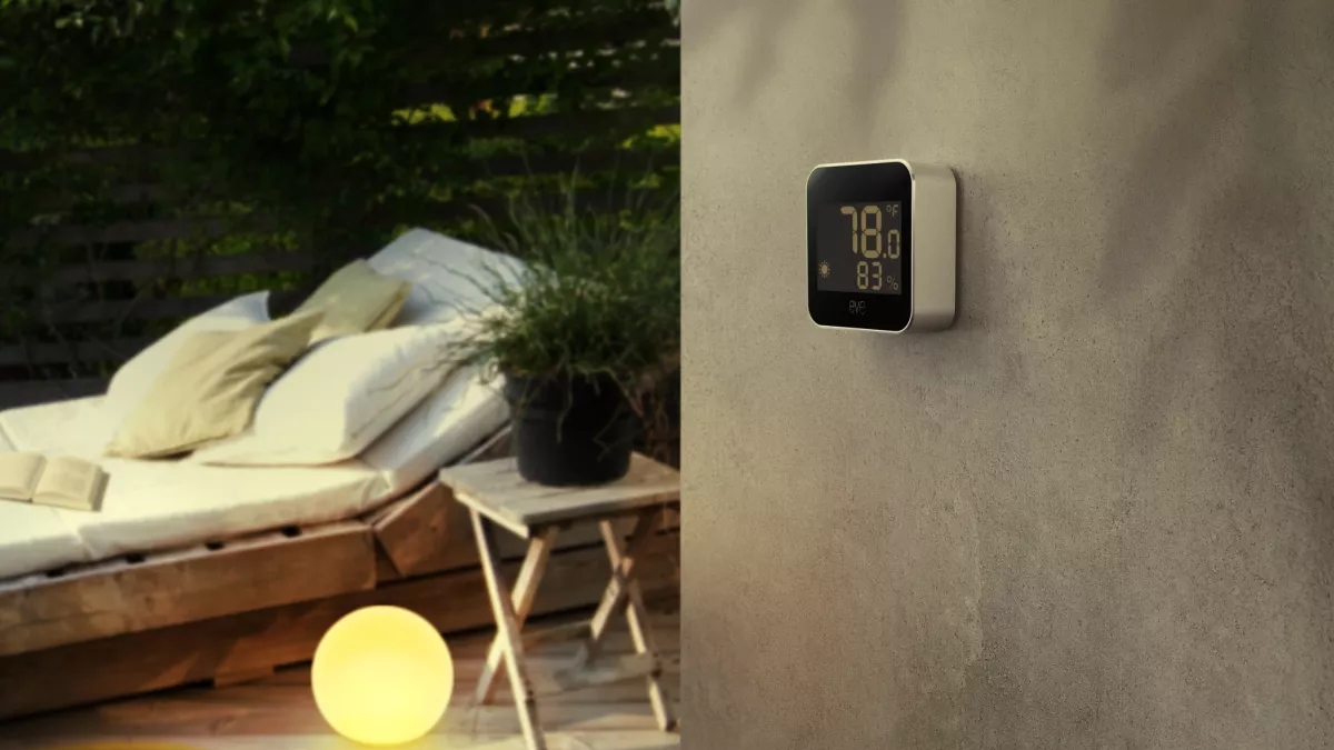 Eve Weather mounted on a wall in an outdoor setting.