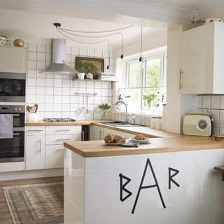 white kitchen with worktop and oven