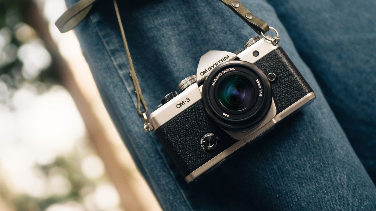 Photographer carrying the OM System OM-3 in an outdoor environment