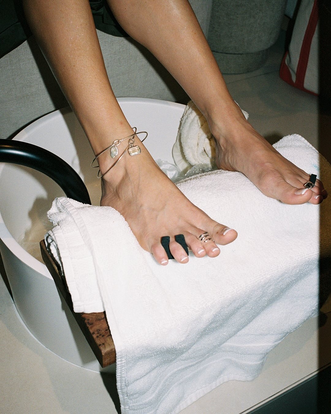 Photo of someone getting a pedicure wearing toe rings