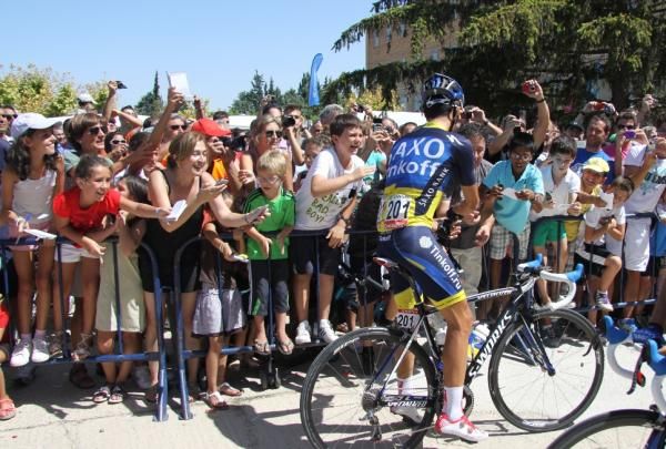Alberto Contador gives autographs before the stage