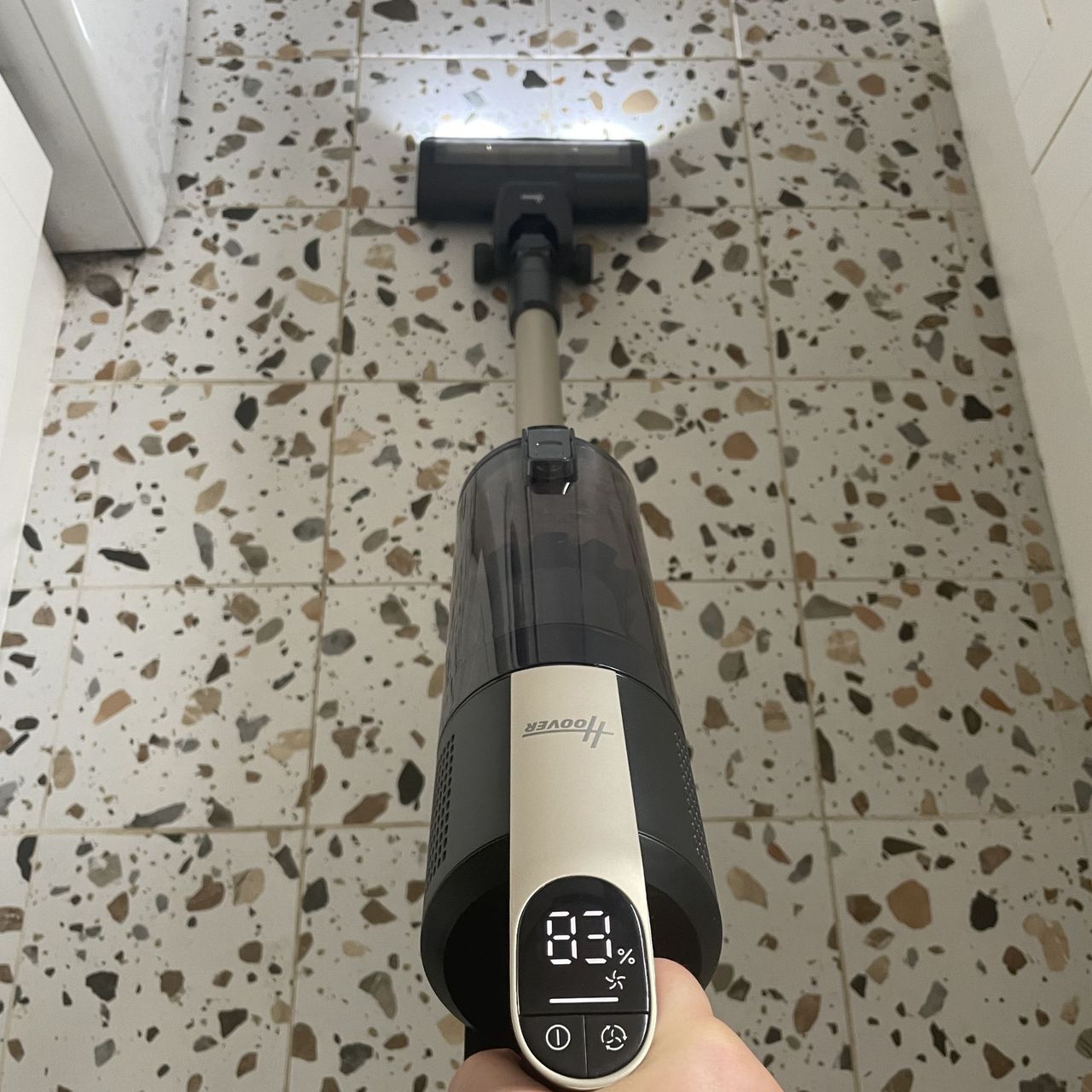 Using the Hoover HF3 Pet DynamicClean Cordless Vacuum to vacuum terrazzo tiled floor in a kitchen