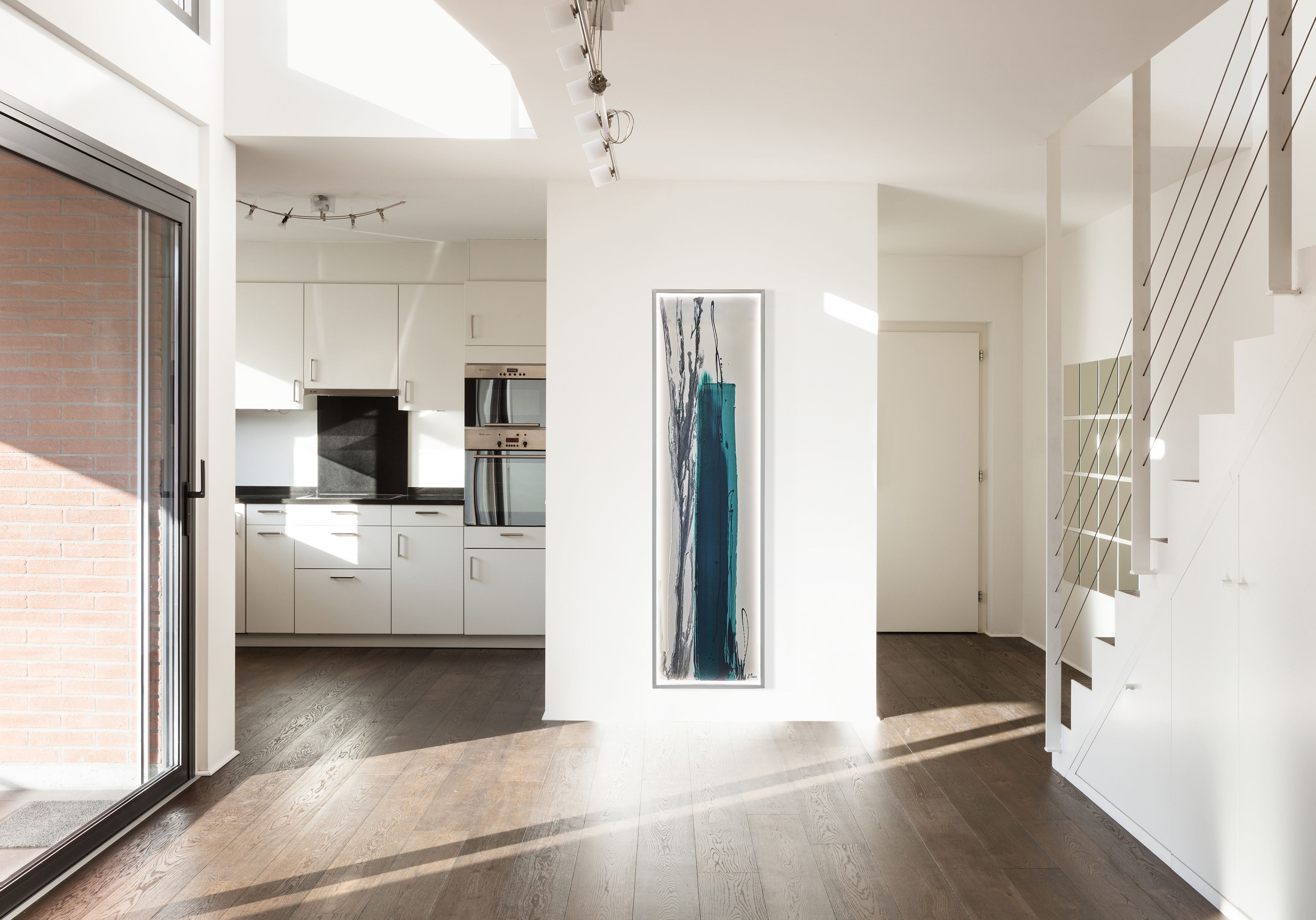 Cinier wall-art radiator that is placed between the kitchen and the and the staircase.