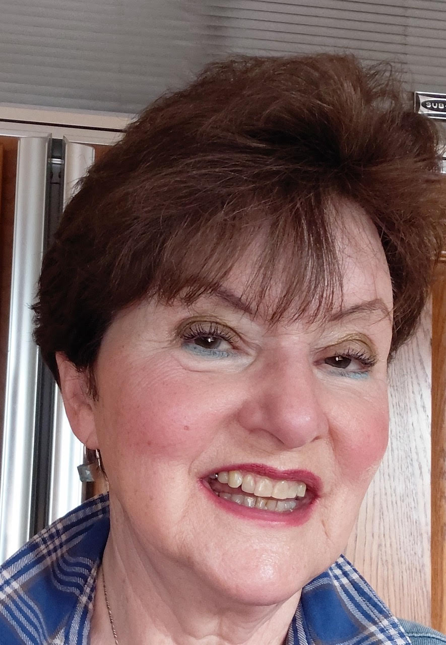 Headshot of woman with brown hair and blue shirt