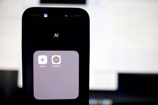 A phone screen with the words "AI" printed above OpenAI and Gemini apps.
