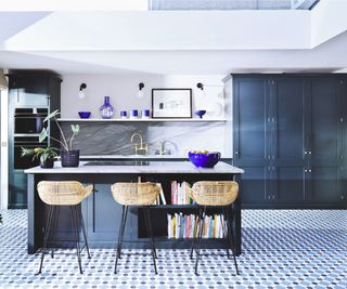 navy kitchen with island incorporating bookshelves