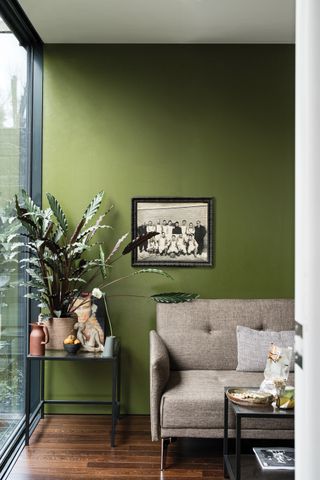 A living room painted bold green Bancha emulsion from Farrow & Ball