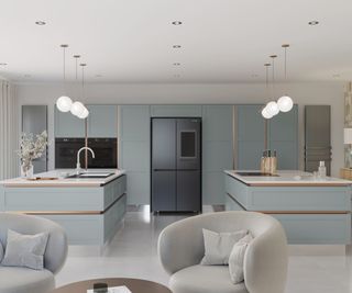 pale blue kitchen with two islands, sink on one, hob on other and back wall with ovens and appliances